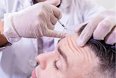Administering injection for cosmetic treatment procedure.
