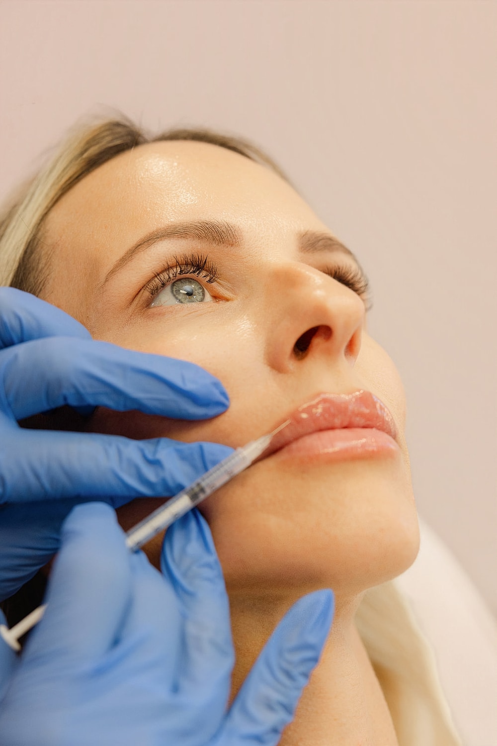 Lip filler injection procedure in a beauty clinic.
